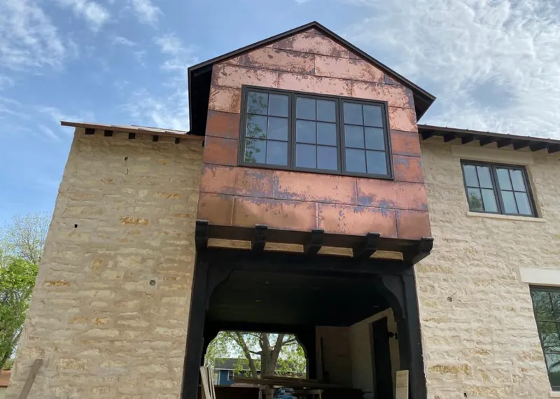 Copper metal panel facade on a stone building for Skylight Installation in Hellertown