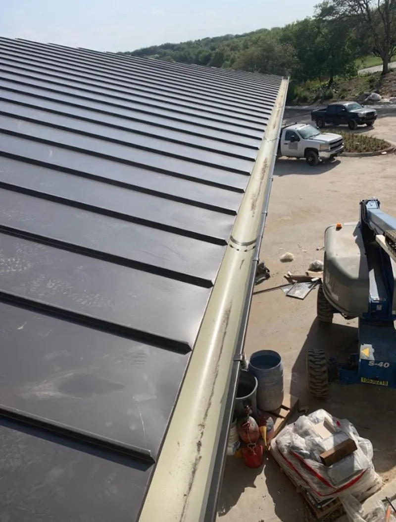 Standing seam panel and gutter detail on a metal roofing jobsite in Hellertown